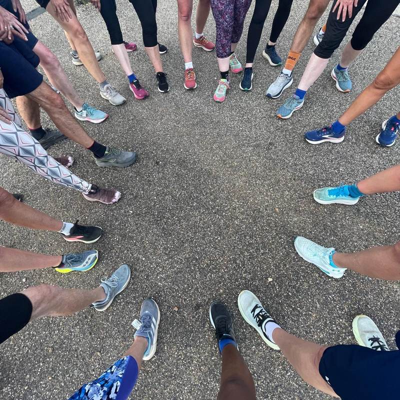 A ring of Jelly Legs members' running shoes, seen from above before a club run
